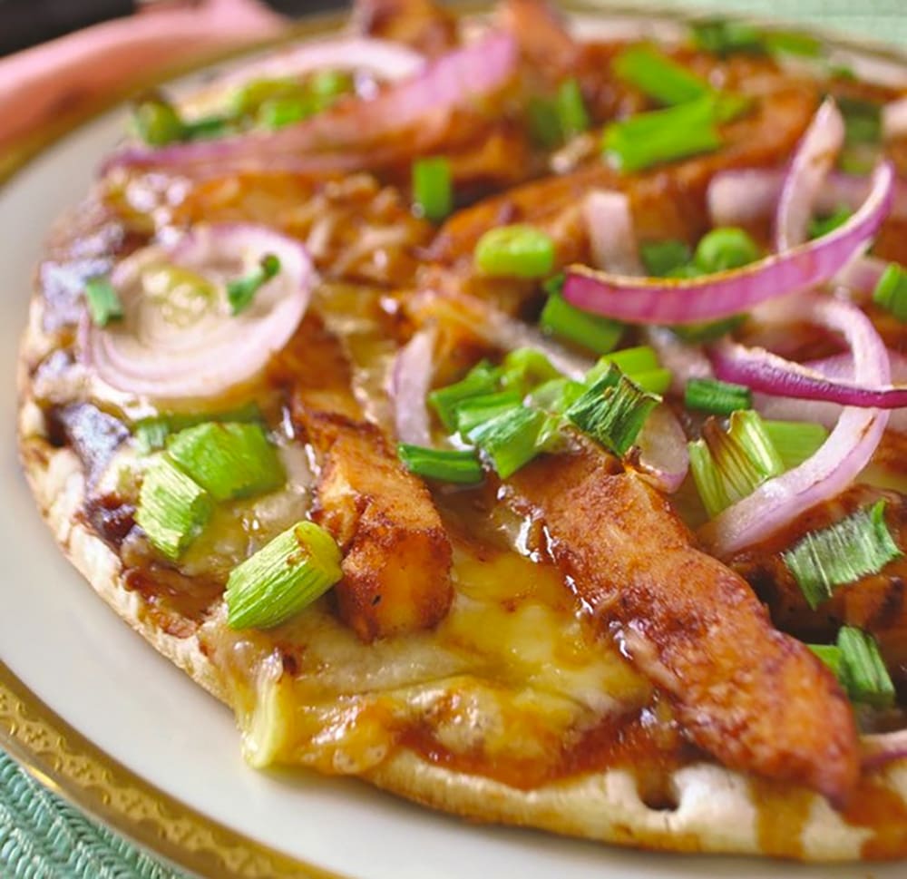 An easy and delicious twist on traditional pizza, this warm and mouthwatering Barbecue Chicken Pizza is a no-stress meal. The recipe uses a pre-made crust and chicken leftovers, mixed with a sweet and smokey barbecue sauce, fresh veggies, and mozzarella cheese to create the ultimate easy weeknight meal. 