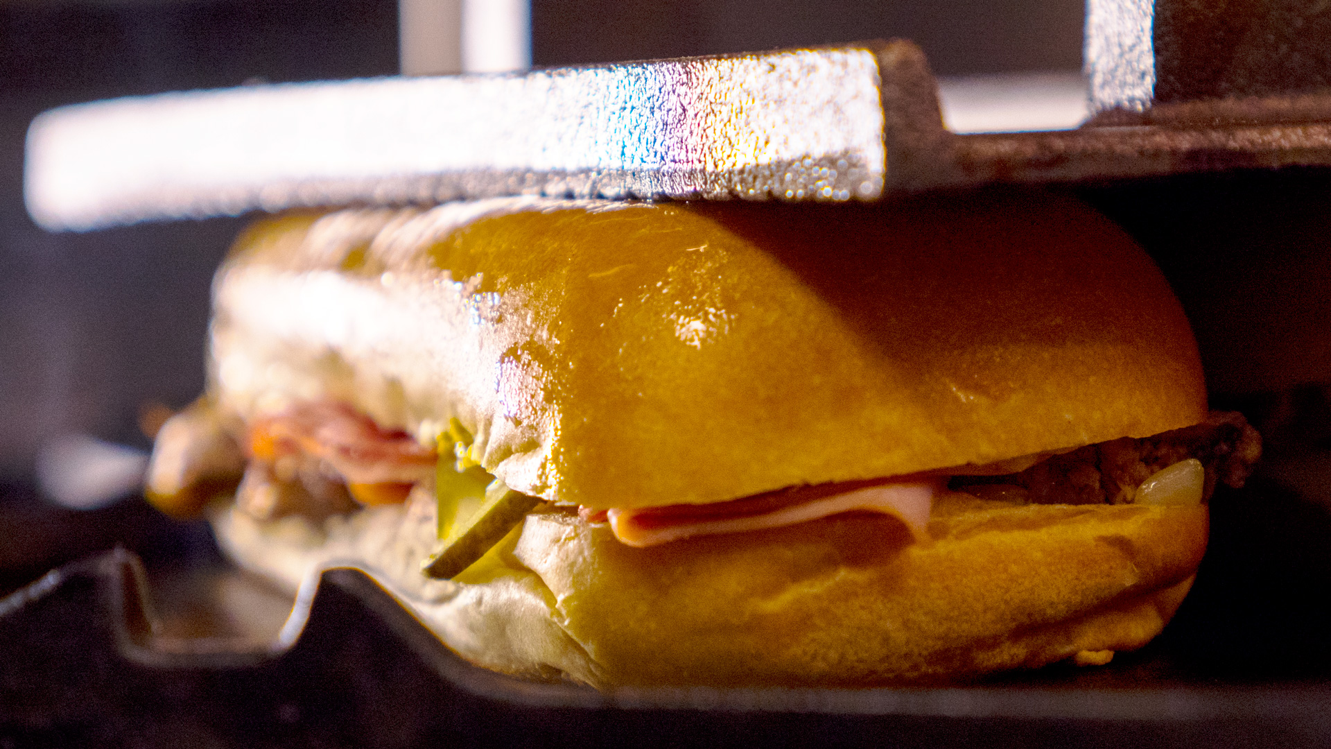 Our classic Cubano sandwich recipe, made famous in the Tampa Florida neighborhood of Ybor City, features mojo-marinated roast pork tenderloin with deli-sliced ham, Genoa salami and Swiss cheese, thin-sliced pickles and mustard- all layered on soft buttery Cuban rolls grill pressed flat and crispy.