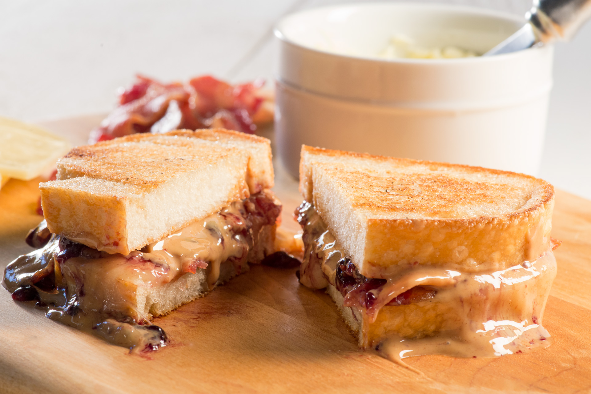 Peanuts, peanuts, peanuts! This luscious melted sharp white Cheddar cheese, salty crispy bacon, and creamy peanut butter sandwich is finished with a touch of sweet blackberry preserves!