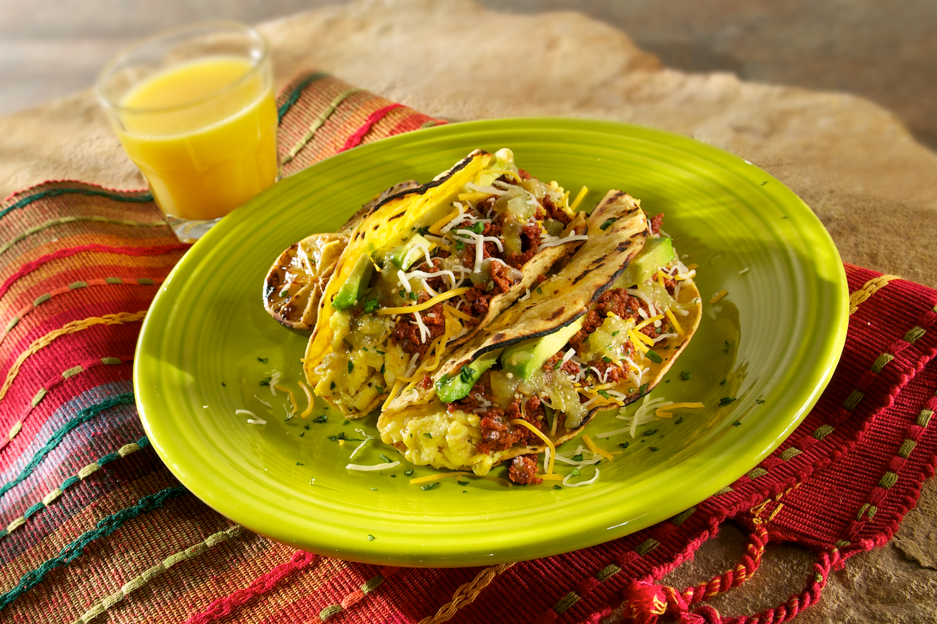 Corn tortillas packed with spicy chorizo and scrambled eggs topped with a tomatillo salsa, Mexican cheese, ripe avocado, and cilantro.