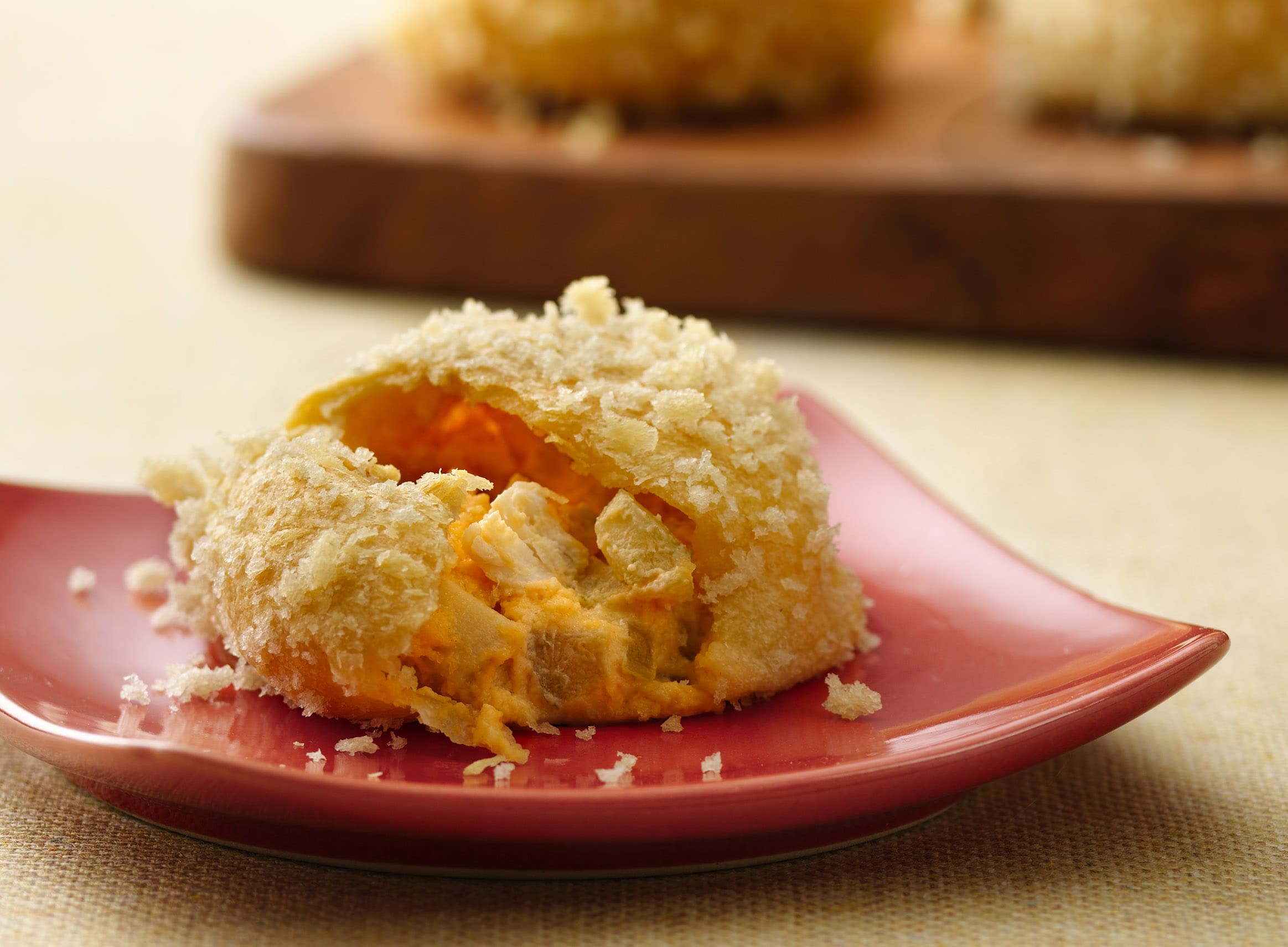 The traditional buffalo chicken dip wrapped into a buttery and flaky crescent roll topped with crunch Panko bread crumbs. These small bursts of flavor make for a perfect party pass-around