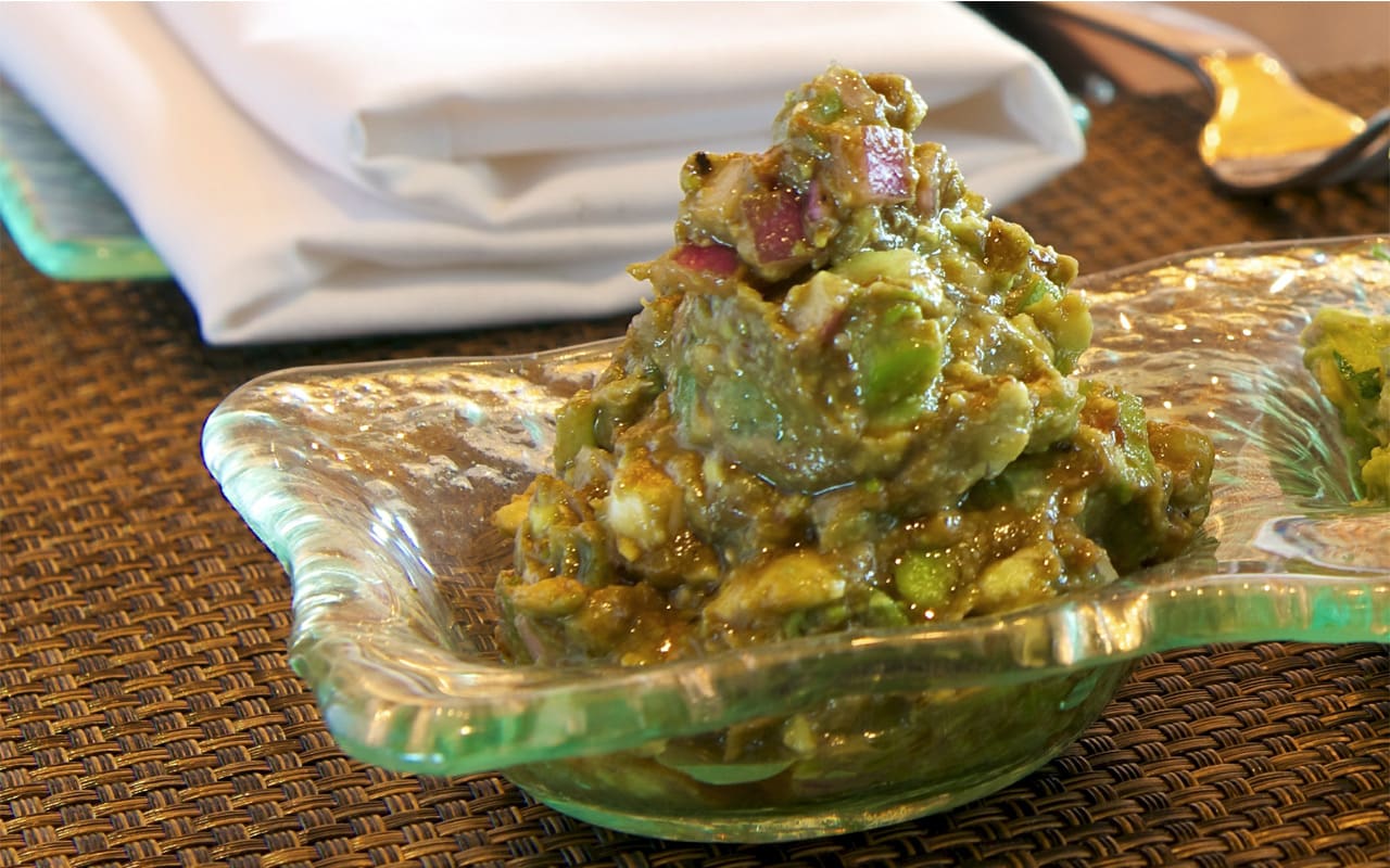 This guacamole recipe combines plum tomatoes, mango, jicama and ripe avocados for a twist on the traditional recipe.