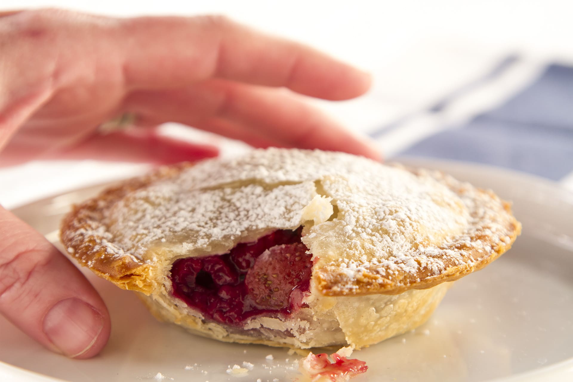 This multi-berry pie is a mini dessert that you can pick up and eat! Fill your pies with your favorite fruit filling or serve a variety, they'll be a hit.