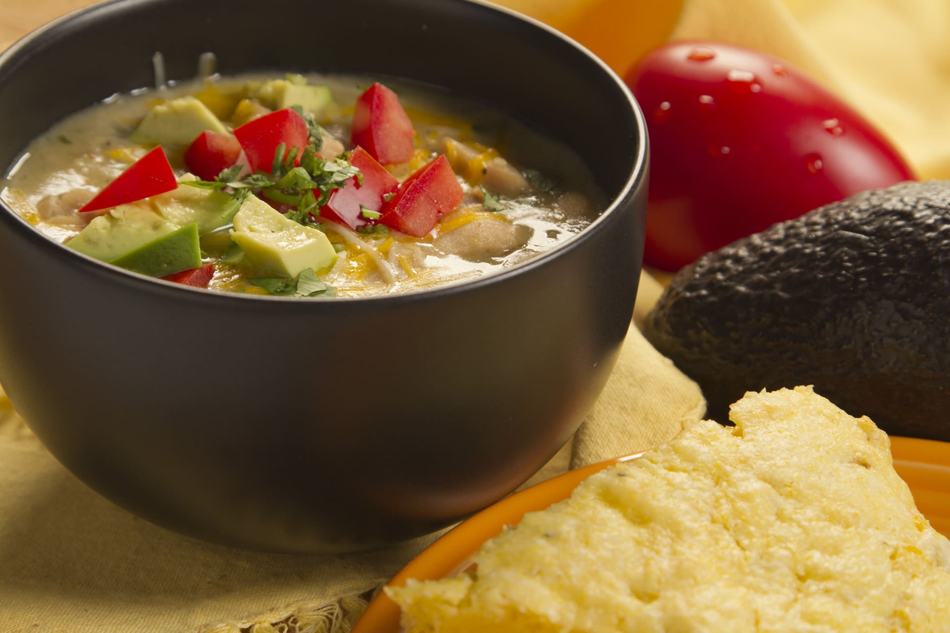 Here’s a crowd-pleasing, white-meat alternative to chili made with beef. This White Chicken Chili is ideal for basketball or football watch parties, tailgating, and casual gatherings! If dark meat isn’t your thing, substitute chicken breasts, chopped. Also if you like it spicy add a bit more red pepper flakes. For garnish, top with diced tomatoes, cheese, green onions and sour cream.