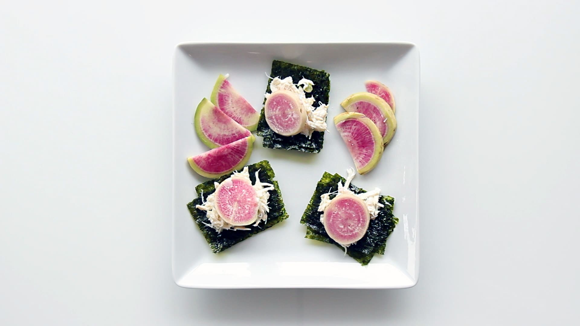 These delicious bite-sized Crab Bites are layered onto GimMe® Organic Sea Salt Seaweed and topped with a crunchy radish. Perfect for a healthy snack or appetizer!