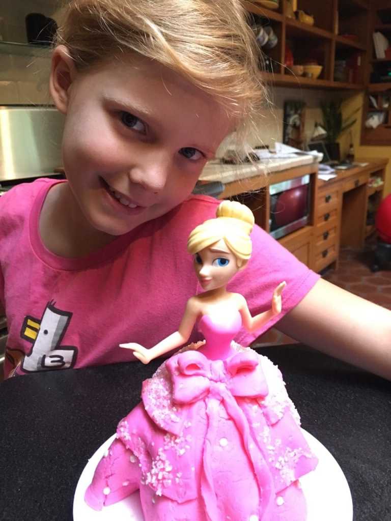 Photo of Chef Penelope with the finished Princess Cake she baked at home.