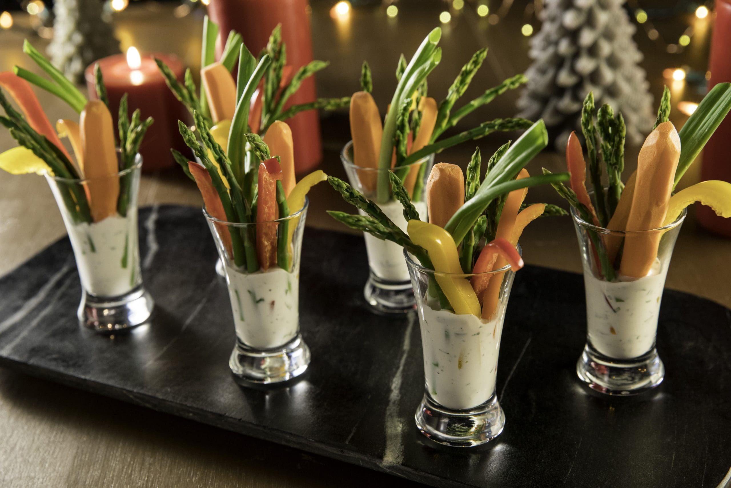 Serve a crisp, fresh assortment of veggies displayed in individual-size shot glasses with buttermilk-herb dip as a fresh & healthy appetizer at your holiday party. Double dipping encouraged!