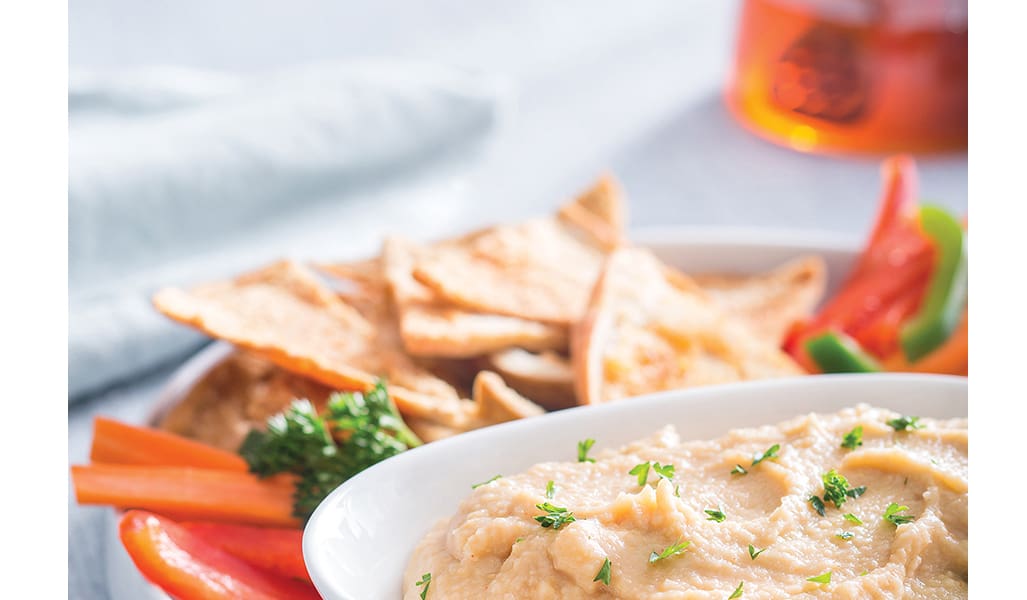 This Moroccan Spiced Hummus is the perfect appetizer to please picky party guests! With a delicious mix of flavors, such as tahini, garlic, honey and garbanzo beans, this hummus recipe has a little something for everyone.
