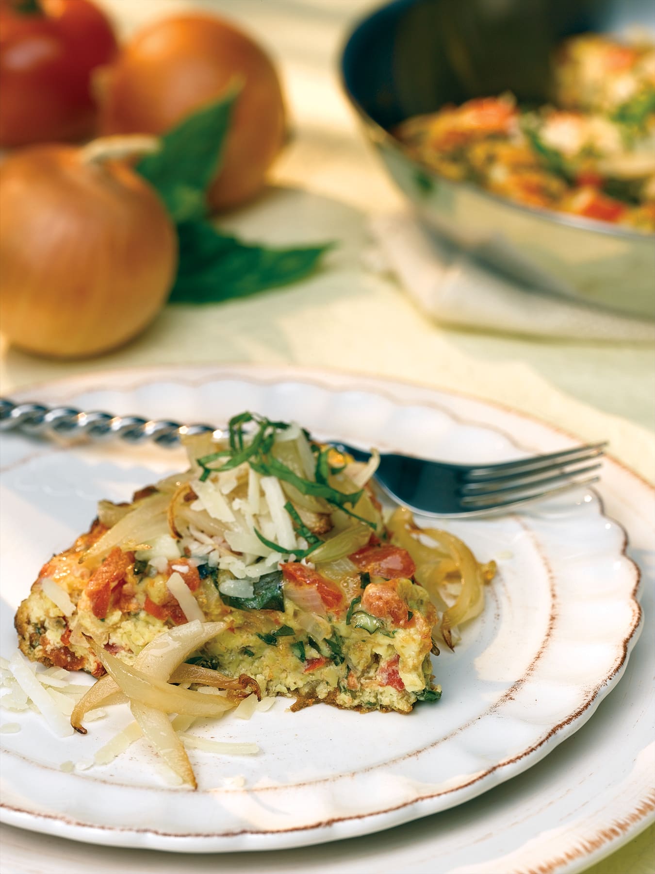 This perfect-for-Easter brunch Frittata is a mouthwatering Frittata recipe made with onion, basil, and fresh tomato.