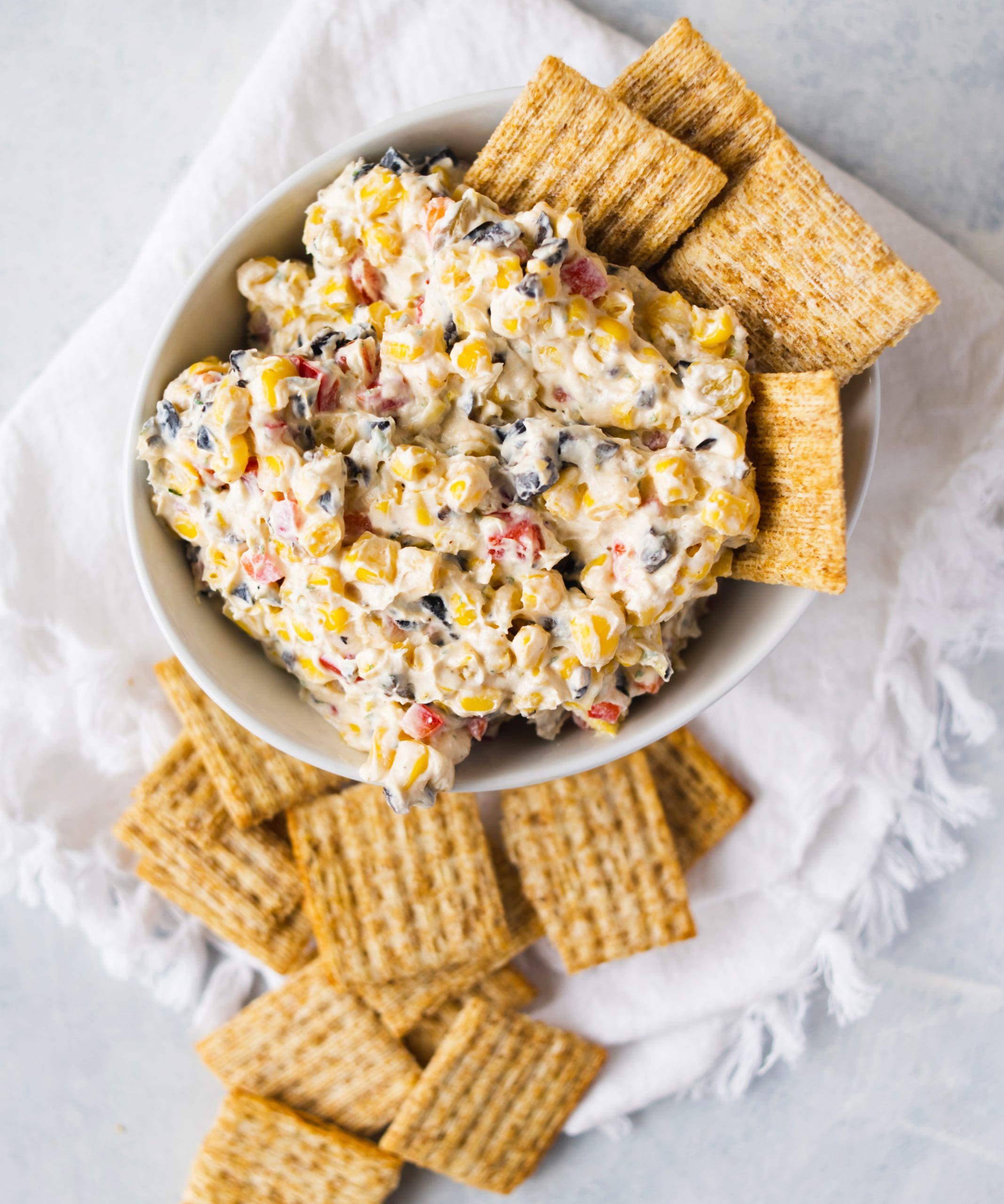 My neighbors a couple of doors down have a pool, and every Memorial Day they invite a few of the neighbors over for swimming and grilling. They always make a corn and cream cheese dip that I tend to circle back to as I make my rounds. This version is inspired by that Memorial Day dip, but I replaced full-fat cream cheese with a lighter version and added more veggies.