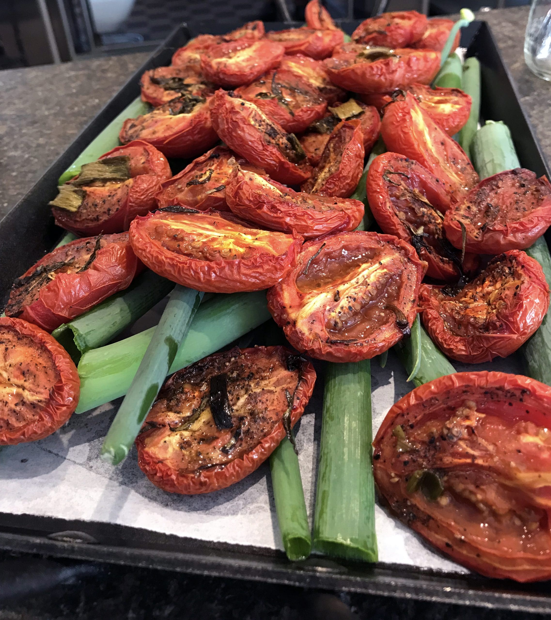 A tray of beautifully roasted tomatoes and herbs served at Cornman Farms.