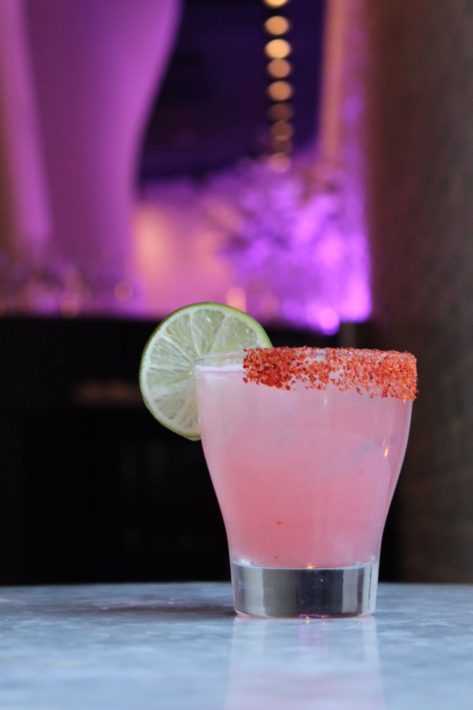Unlike a classic Paloma, the Paloma Escobar uses a citrus and spice rim to balance the acidity of the fresh lime and grapefruit juice. The introduction of simple syrup further rounds out the flavors of the fresh juices.