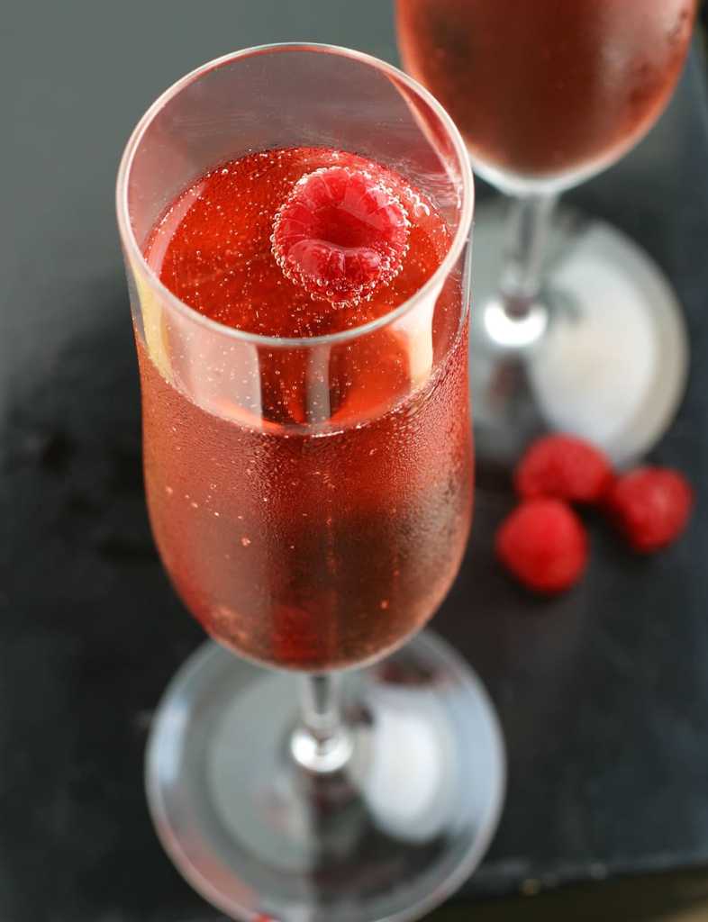Raspberry Lemon Lime and Ginger Beer champagne made with raspberry puree, brooklyn crafted ginger beer, limoncello, champagne and lime juice with raspberry garnish.