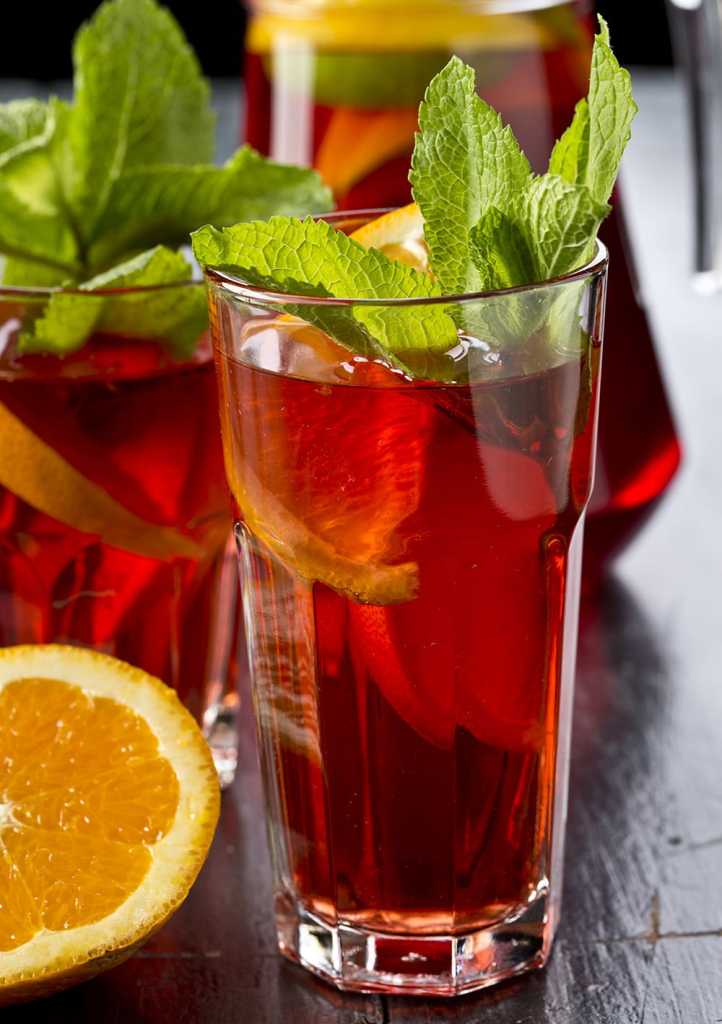 Citrus basil spiked sweet tea made with water, tea, sugar, lemons, oranges, rum and basil.