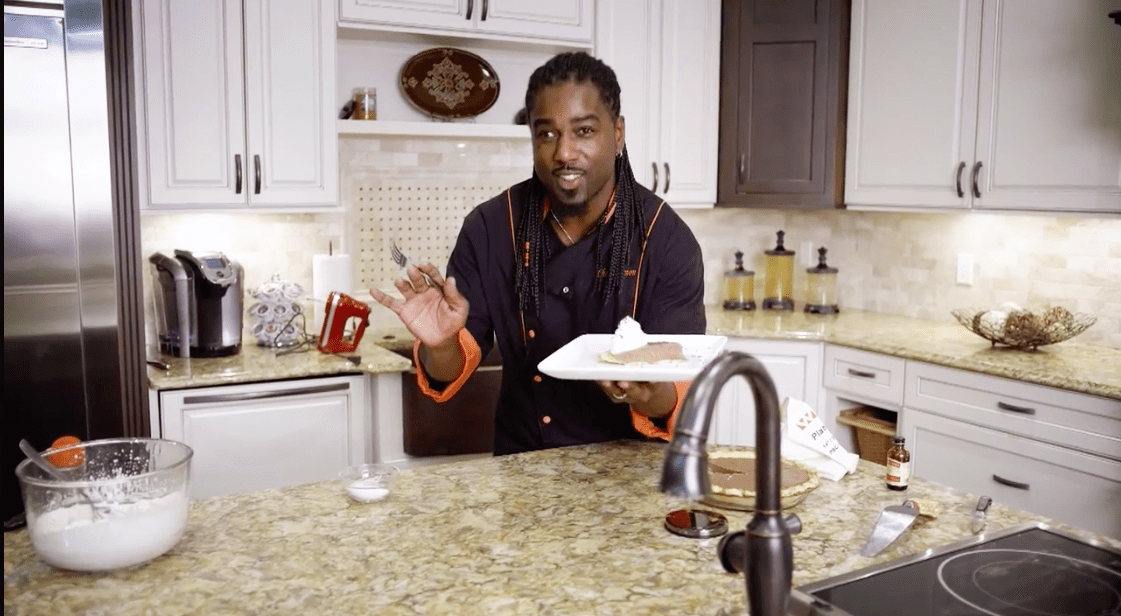 Chef Ace Champion holds up his finished chocolate kahlua cream pie with madagascar creme.