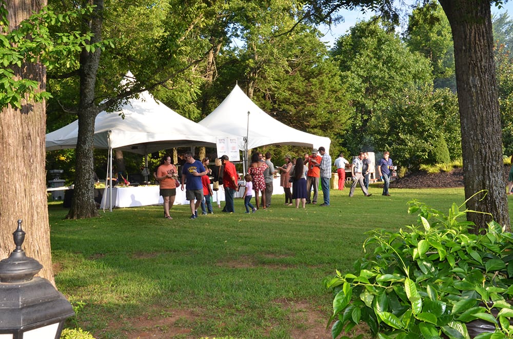 guests at the Fayetteville Roots Festival mingle at the guest chef tents.
