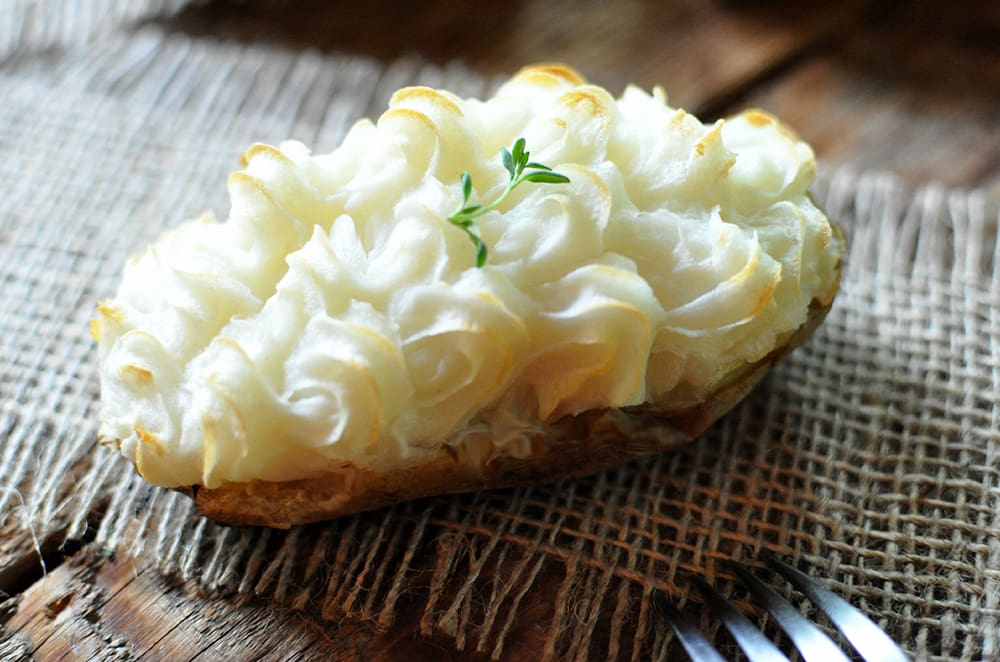 A twice baked potato topped with truffle cream.