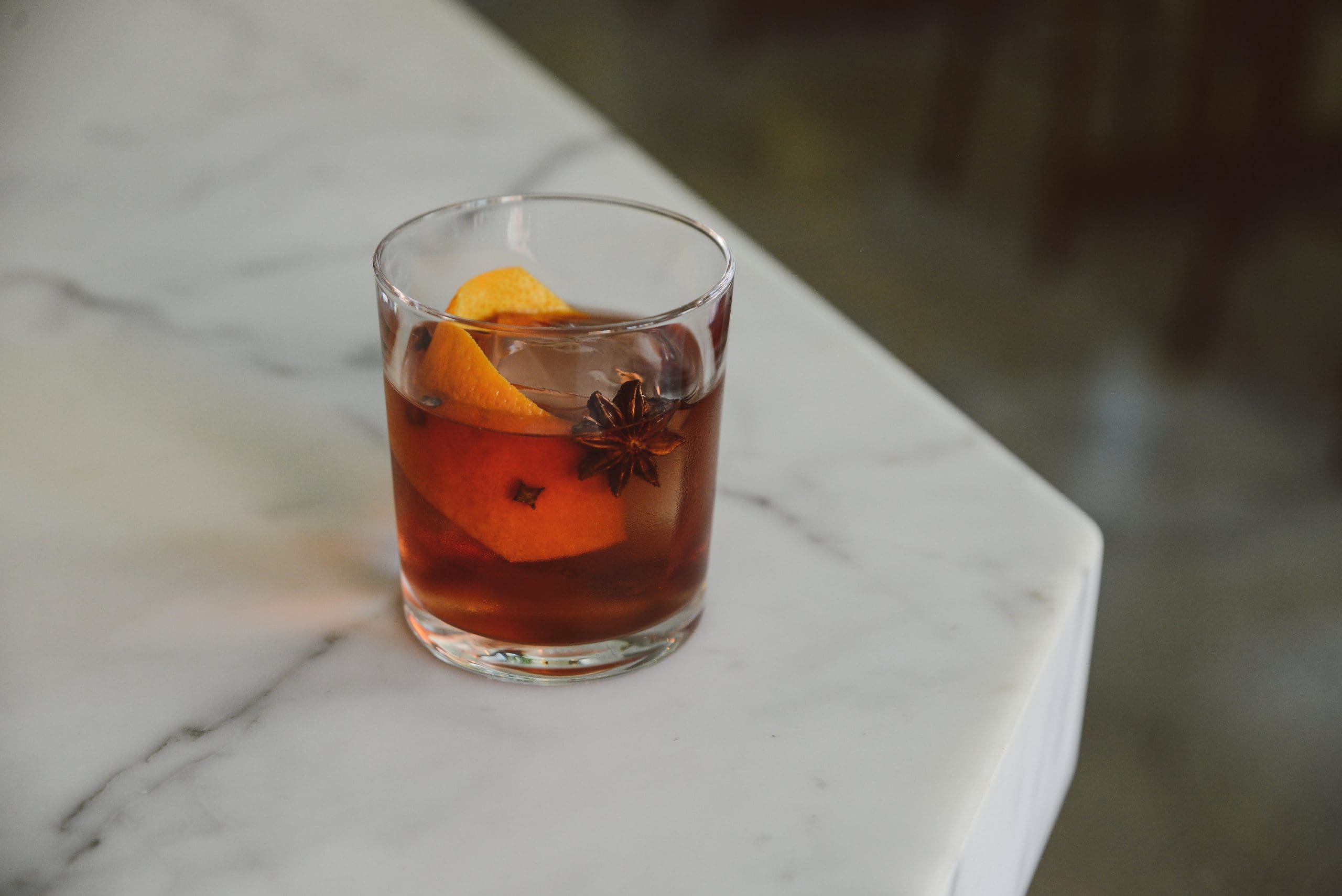 Add all ingredients to a mixing glass, add a large scoop of ice, stir for 7 seconds, strain into a rocks glass over fresh ice and garnish with an orange twist studded with cloves and a star anise.