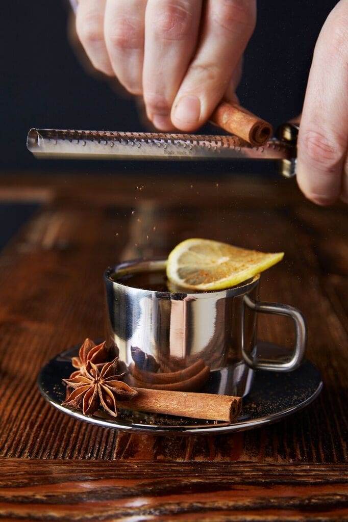 Combine water and demerara sugar. Heat in microwave until sugar dissolves (about 45 seconds). Add Old Monk XXX Indian Rum, a fresh squeeze of lemon juice, and 2 dashes of Bittercube Blackstrap Bitters. Give a few stirs, then garnish with lemon wheel and freshly grated cinnamon over the top.
