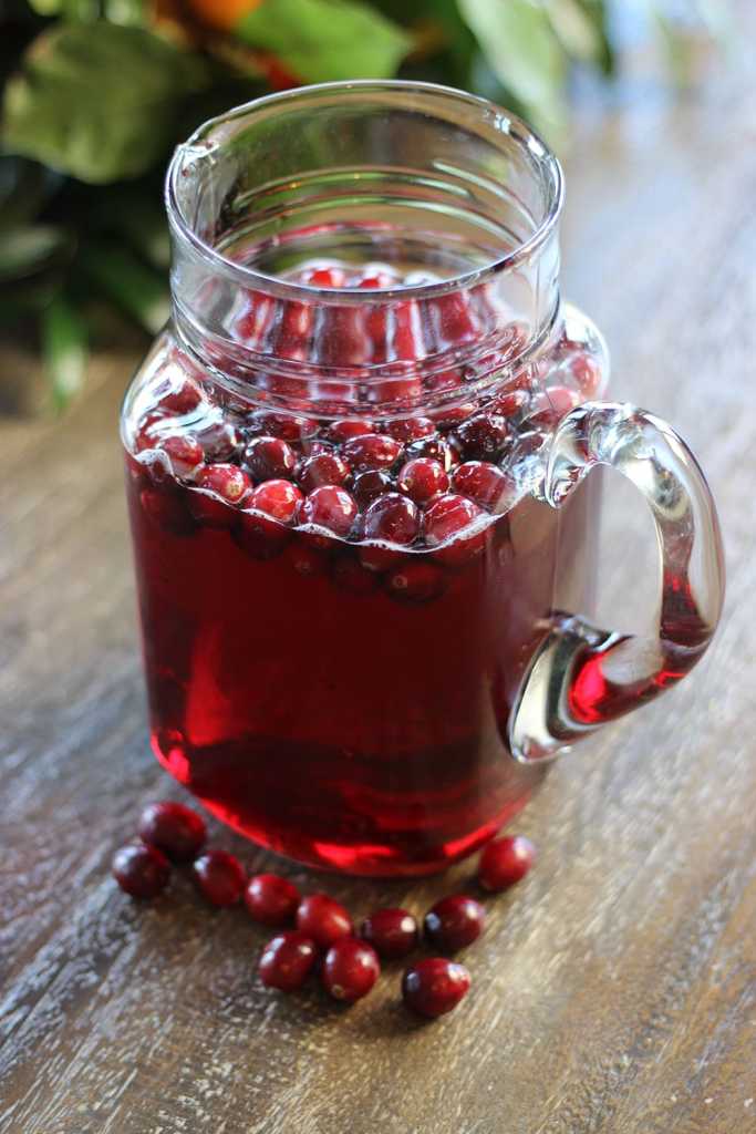 Pour ingredients into a large punch bowl or pitcher and stir. Top with raspberries or cranberries.