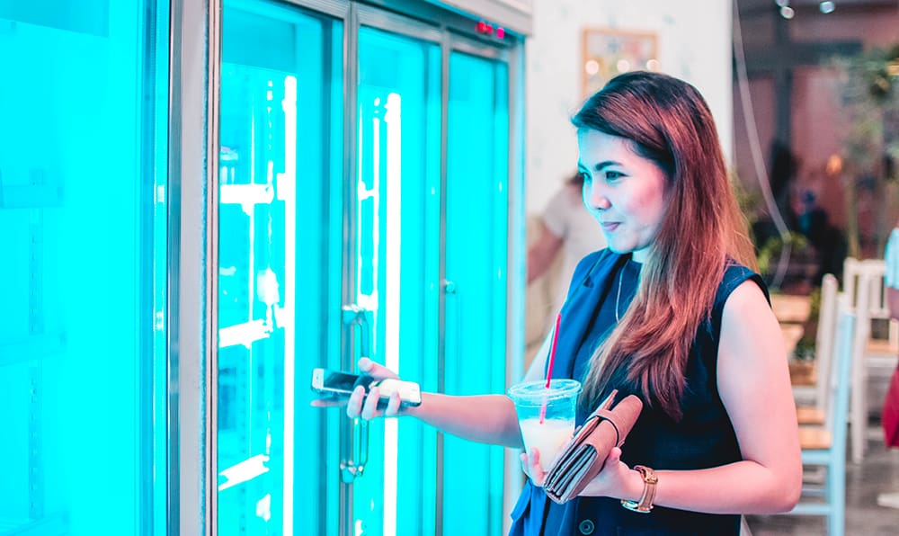 A shopper confronts the variety of contemporary frozen foods in a grocery store.