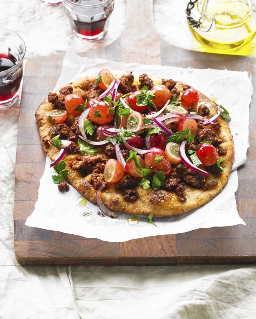This recipe for Mediterranean Pizza with Grapes is a take on a classic pizza, made with naan. Filled with the protein of your choice browned and seasoned with tomato paste, olive oil, lemon juice, paprika and cayenne.