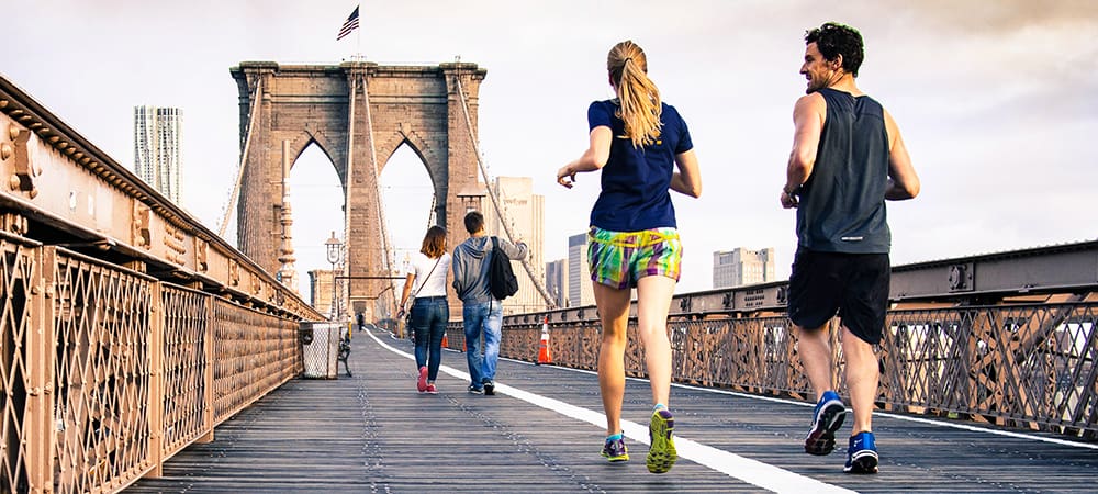Joggers run across the Brooklyn Bridge in New York City.