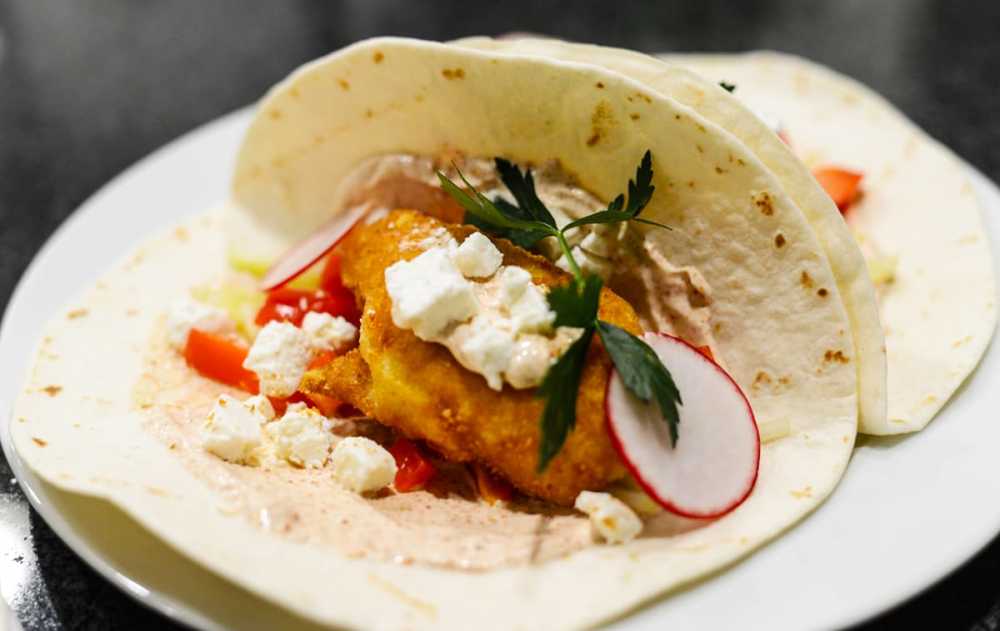 These quick and easy fish tacos, from food blogger Christopher Mohs, are made with tortillas, fish fillets, sour cream, cucumber, red pepper and feta cheese.
