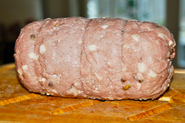 A whole mortadella sausage after being ground by hand, backed and chilled in the refrigerator for two days.