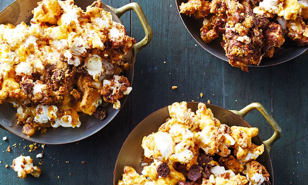 This delicious version is tossed in a large bowl, with marshmallows and chocolate chips, then coated with a hot-sugar mixture.