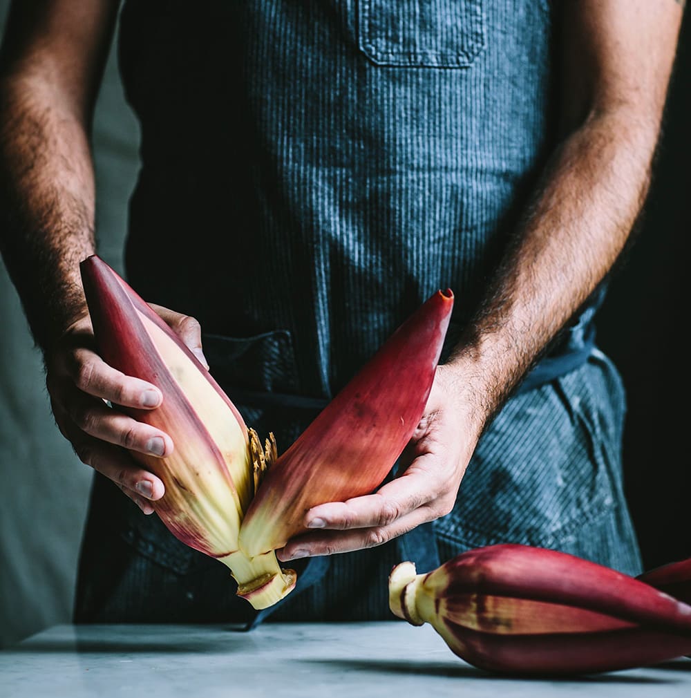 A chef shows readers how to prepare a banana blossom in The Wicked Healthy Cookbook, which extols the virtues and health benefits of a plant-based diet.