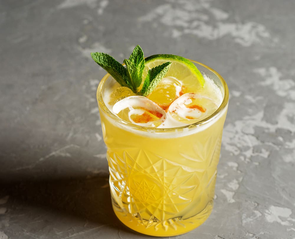 Lemon basil margarita with a mint-leaf garnish.